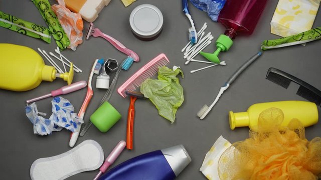 Plastic waste and pollution in the bathroom. Packaging of the hygiene and beauty products: toothbrushes, toothpaste, shampoo bottle, cotton buds, disposable razor, nappies, single-use sanitary pads