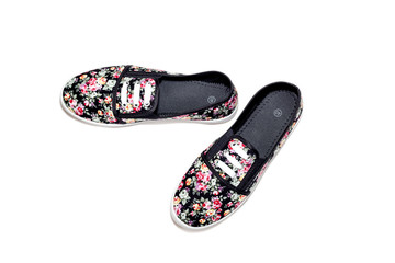Women's sports, black shoes with floral pattern on a white background close-up