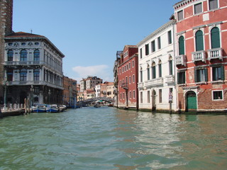 The beauty of the unique Venetian architecture surrounded by water streets and avenues against the backdrop of a clear blue summer sky.