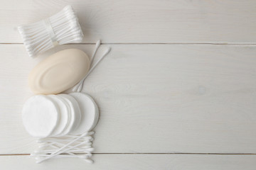 Various personal care products. Cotton pads and sticks, soap, towel on a white background. top view. place for text