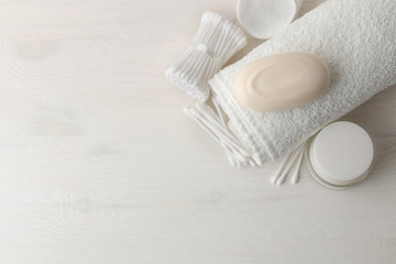 Various personal care products. Cotton pads and sticks, soap, towel on a white background. top view. place for text