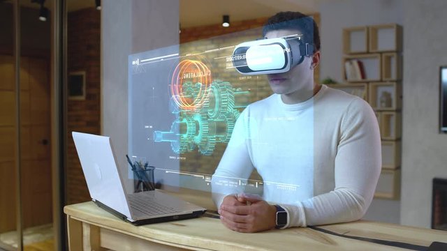 Mechanical engineer checking on a project wearing vr set, futuristic jobs, AR. Virtual screen, heads up display, augmented reality