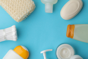 Various personal care products. Face cream, Soap, lotions, cotton pads and sticks on a blue phone. spa. top view