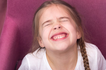 Little girl shows her teeth. Baby teeth concept.