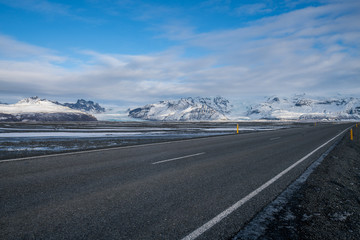 Fototapeta na wymiar Rural curve highway road among the snow mountain in Iceland