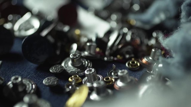 Closeup Of Various Buttons In A Denim Clothing Textiles Factory.