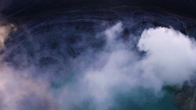 Crater of Ijen volcano, Java, Indonesia. Landscape with the green lake and the smoke