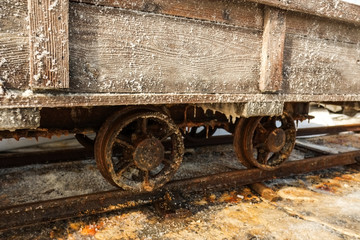 Fototapeta na wymiar Close up of rusty salt cart wheels