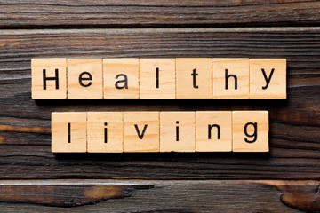 Healthy Living word written on wood block. Healthy Living text on wooden table for your desing, concept