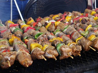 Meat and vegetables barbeque on skewers outdoors, close up