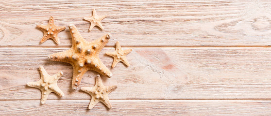 Starfish, seashells on a wooden table, top view, flat lay with copy space banner