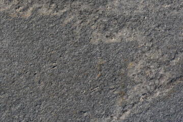 Texture of gray uneven granite slab