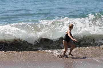 Mature woman on the pacific ocean waves