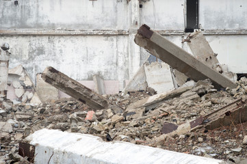 The remains of a large building destroyed in a foggy haze. Background.