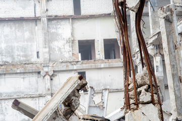 The remains of a large building destroyed in a foggy haze. Background.