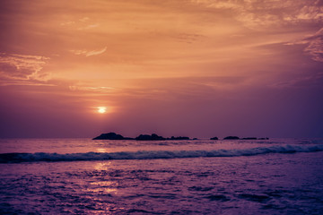 Beautiful orange sun at sunset and a path of light on the waters of the Indian Ocean