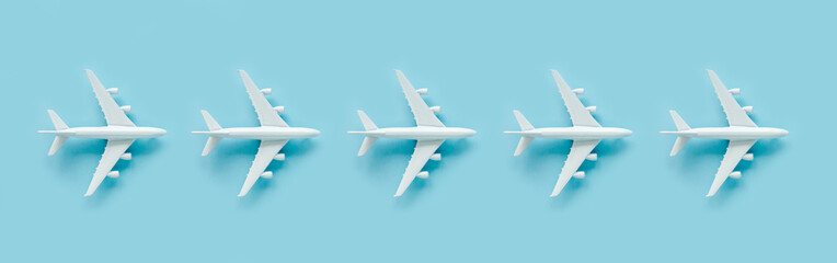 Pattern, seamless white model airplane texture, plane on blue background. Top view, flat lay. Travel, vacation concept. Banner.