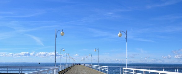 Wooden pier in Jurata town at sunny, summer day. Coast of Baltic Sea at Hel peninsula, Poland. Panoramic view
