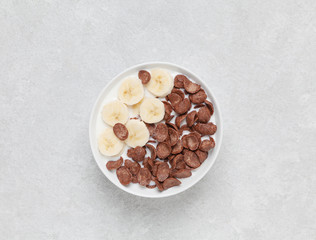 Crispy chocolate flakes in a bowl with milk and banana. Delicious healthy Breakfast