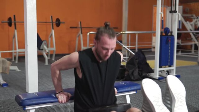 Athlete guy lifts weights in the gym. Sport, health, lifestyle.