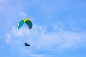Skydiver On Colorful Parachute In Sky. Active Hobbies