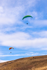 Skydiver On Colorful Parachute In Sky. Active Hobbies