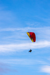 Skydiver On Colorful Parachute In Sky. Active Hobbies