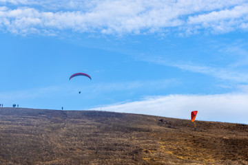 Skydiver On Colorful Parachute In Sky. Active Hobbies