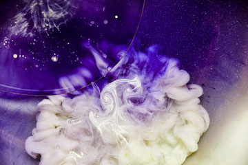 Beautiful abstraction in shades of blue and purple of liquid paints © dominikab