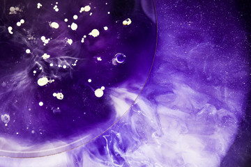 Beautiful abstraction in shades of blue and purple of liquid paints © dominikab