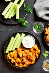 Cauliflower buffalo wings with celery and sauce