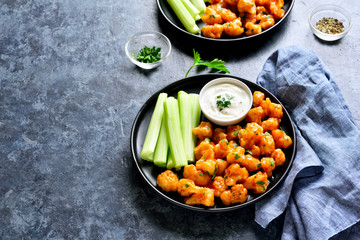Cauliflower buffalo wings with celery and sauce