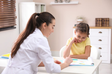 Little girl visiting professional nutritionist in office