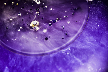 Beautiful abstraction in shades of blue and purple of liquid paints © dominikab