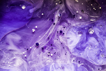 Beautiful abstraction in shades of blue and purple of liquid paints © dominikab