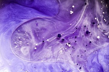 Beautiful abstraction in shades of blue and purple of liquid paints