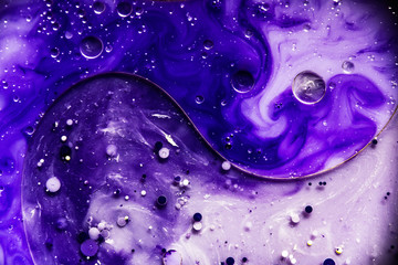 Beautiful abstraction in shades of blue and purple of liquid paints © dominikab