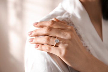 Obraz na płótnie Canvas Young woman wearing beautiful engagement ring, closeup