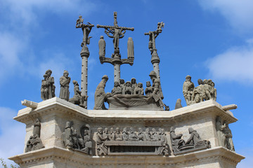 Fototapeta na wymiar The newly restored 18th century sculpture on top of the triumphal arch or gateway of the dead at Pleyben parish close in Brittany, France.