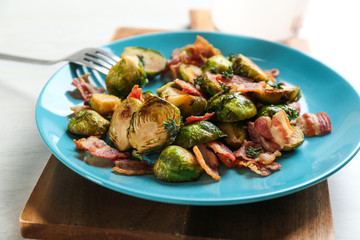 Roasted brussels sprouts with bacon on plate, closeup