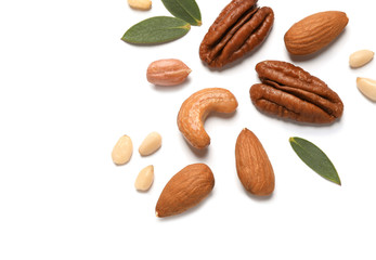 Different delicious nuts on white background, flat lay. Space for text