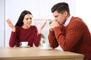 Couple having quarrel in cafe. Relationship problems