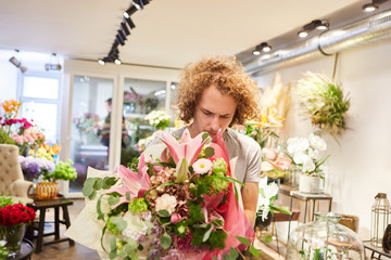 Florist ties a bouquet of flowers as a gift