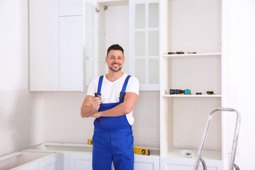 Portrait of worker with screwdriver in kitchen