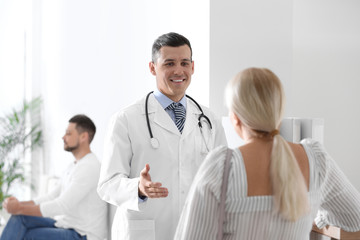 Fototapeta na wymiar Doctor talking with patient in hospital hall