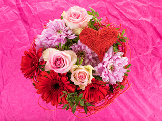 Flower bouquet with roses, gerber blossoms, dahlias and heart shaped ornament