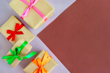 Gifts for the holiday. Gift boxes on a colorful paper background. Festive background and boxes of...
