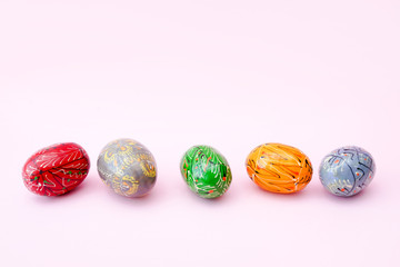 Colorful easter eggs isolated over pink background, copy space