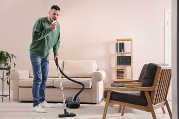 Man with dust allergy cleaning his home