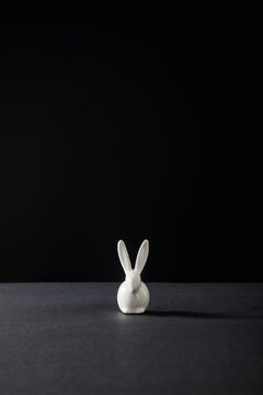 Decorative bunny isolated on black background, panoramic shot